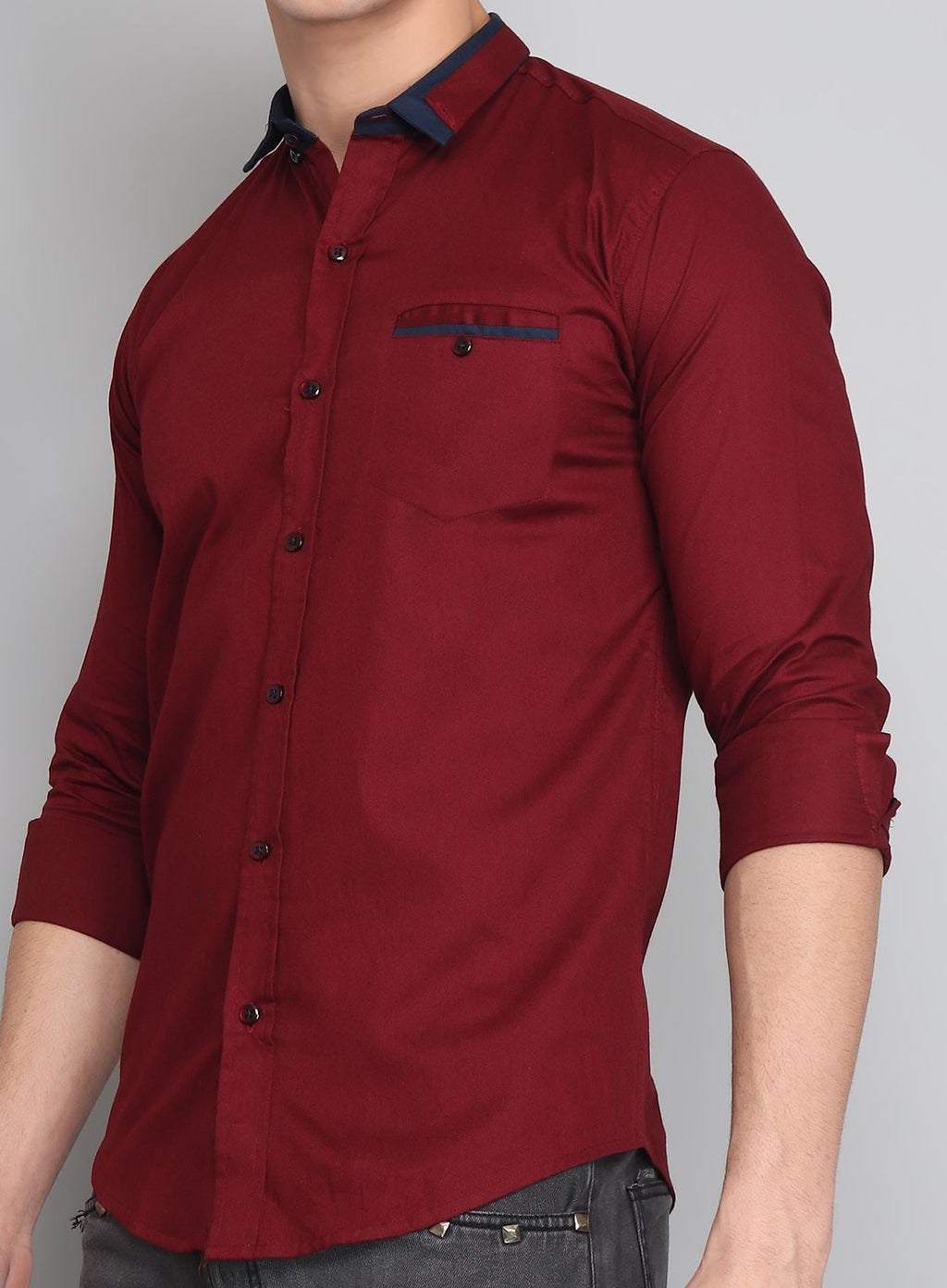 a man wearing a red shirt and jeans