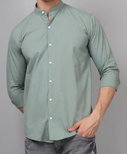 a man wearing a green shirt and jeans