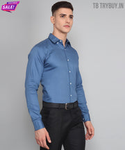 a man wearing a blue shirt and black pants