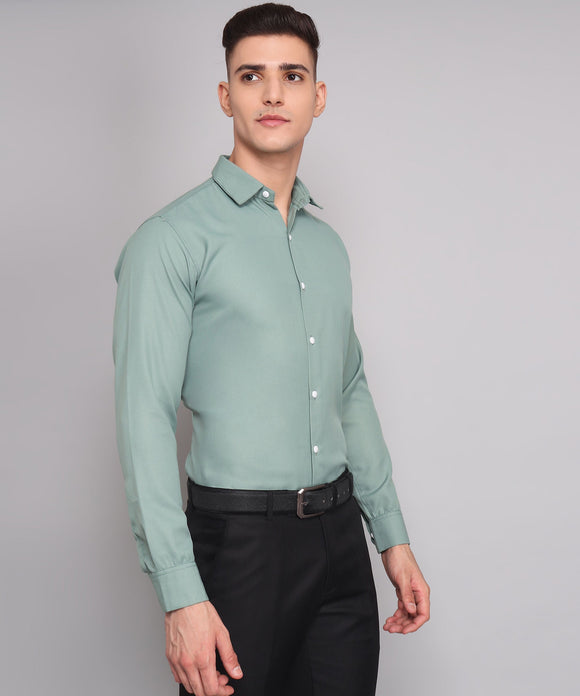 a man wearing a green shirt and black pants