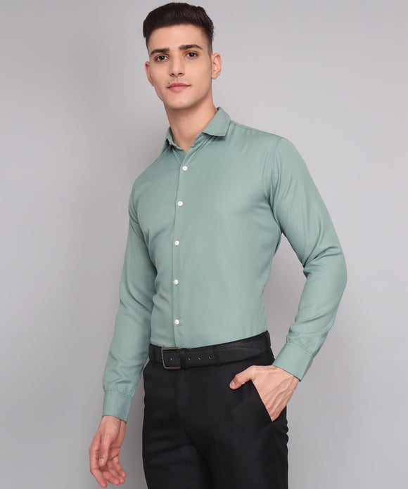 a man wearing a green shirt and black pants