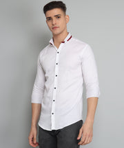 a man wearing a white shirt and black pants