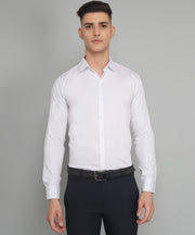 a man in a white shirt and black pants