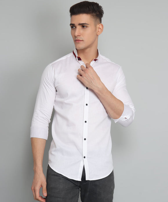 a man in a white shirt adjusting his tie