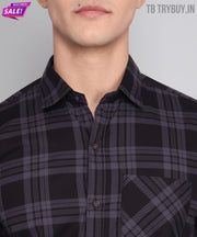 a man wearing a black and grey plaid shirt