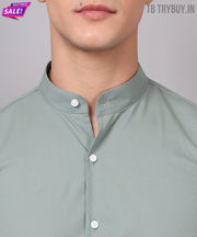 a close up of a person wearing a green shirt