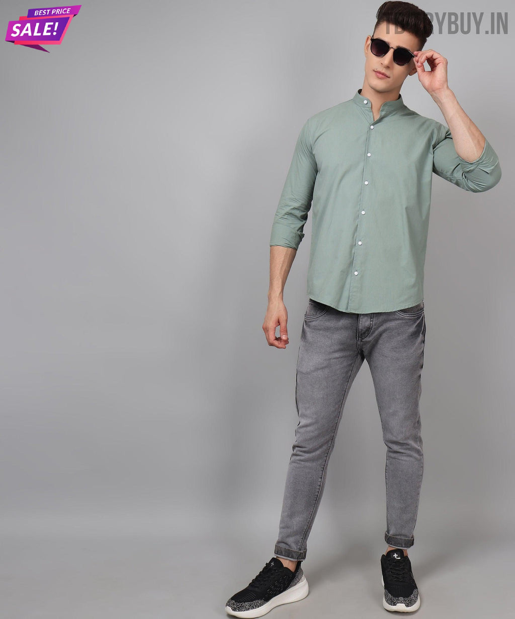a man in a green shirt and grey pants