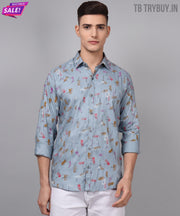 a man wearing a blue shirt with a pattern on it