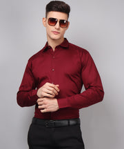 a man wearing a red shirt and black pants
