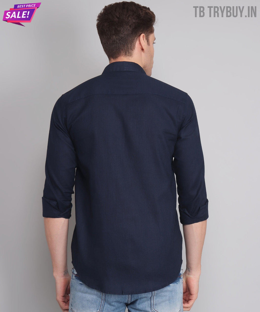 a man wearing a dark blue shirt and jeans