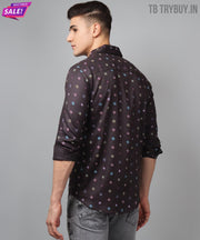 a man wearing a black shirt with colorful squares on it