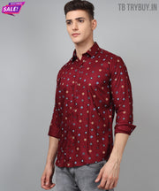 a man wearing a red shirt with blue and yellow squares on it