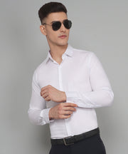 a man wearing a white shirt and black pants