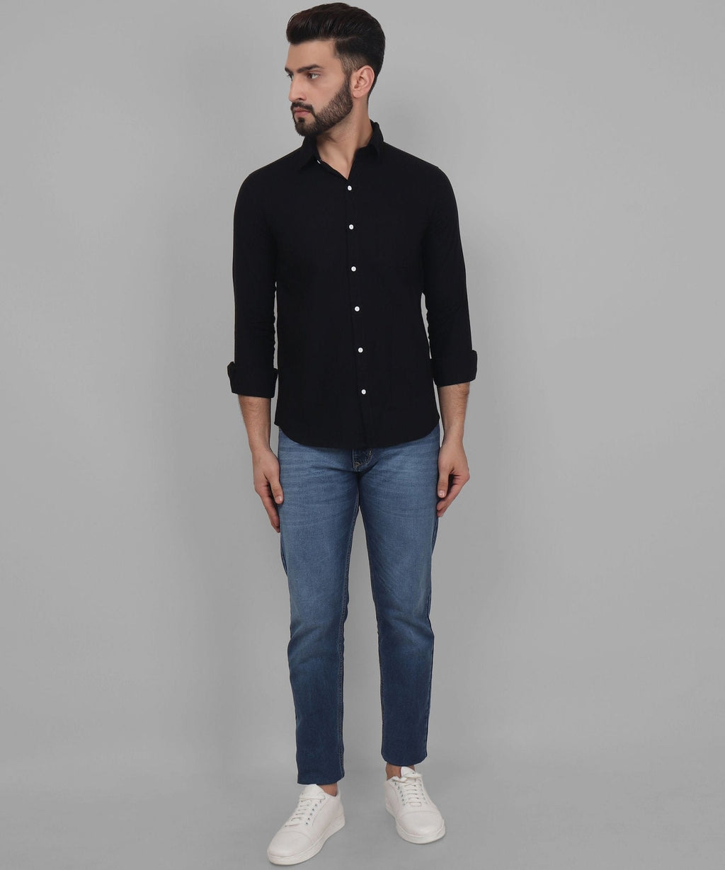 a man wearing a black shirt and jeans