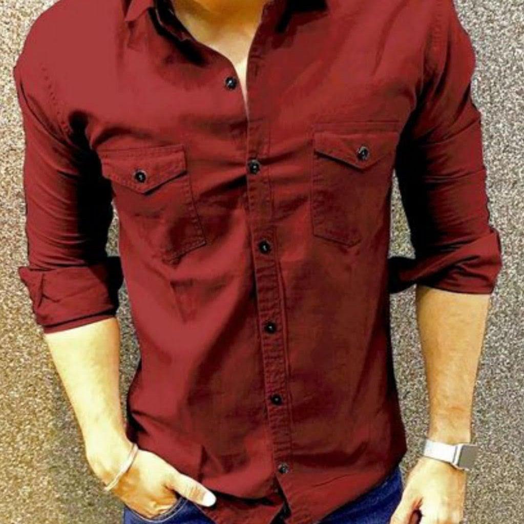 Man wearing a maroon shirt with blue jeans