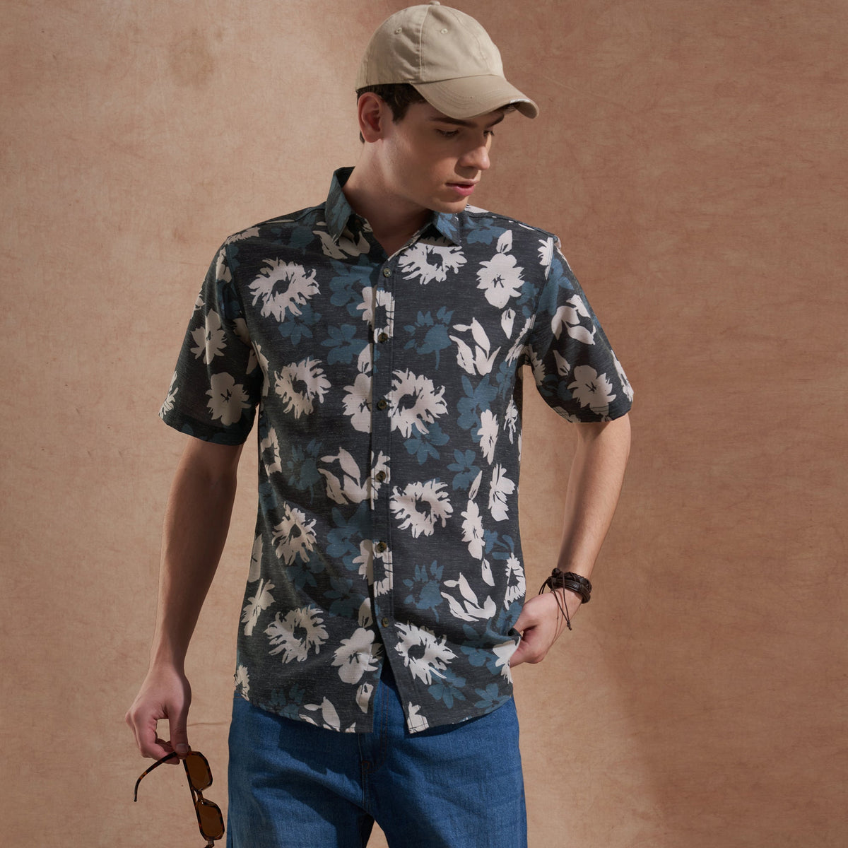 Man wearing a charcoal grey floral-printed slim-fit short-sleeve shirt