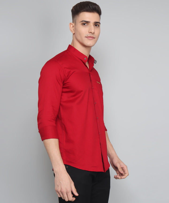 a man wearing a red shirt and black pants