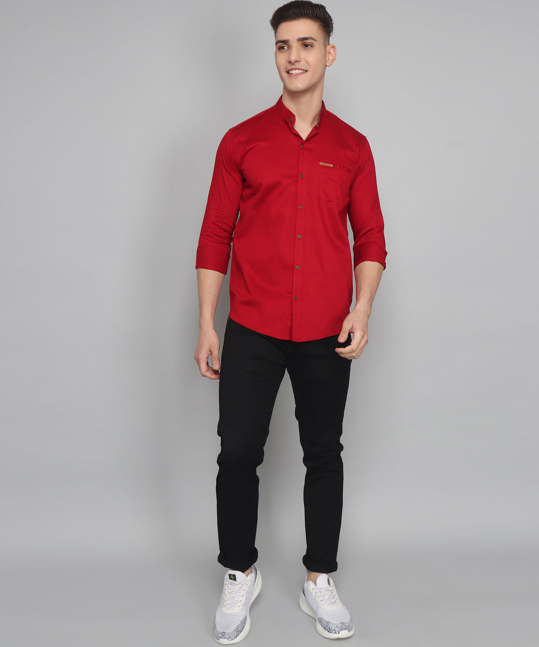 a man wearing a red shirt and black pants