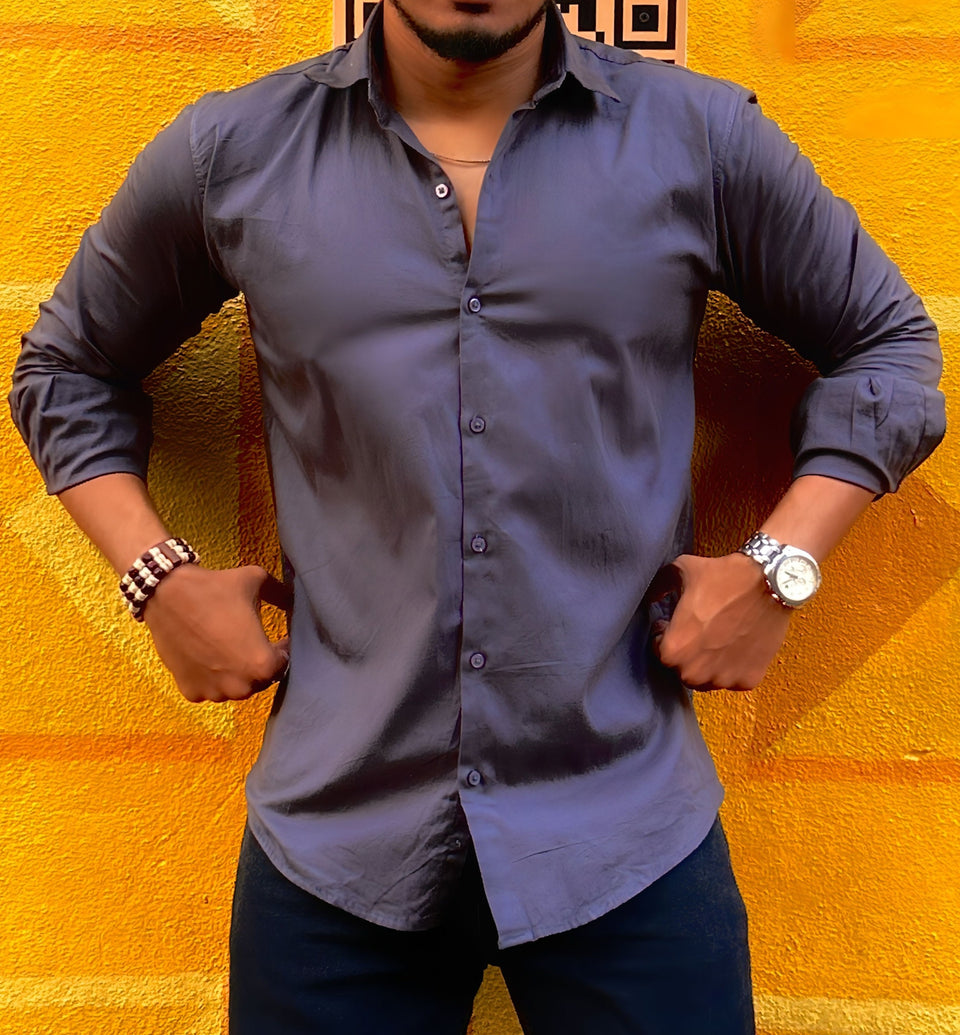 a man standing in front of a yellow wall
