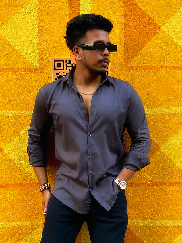 a man standing in front of a yellow wall