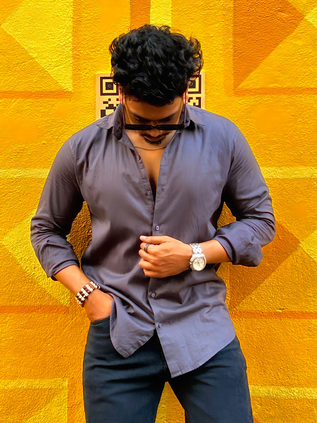 a man standing in front of a yellow wall