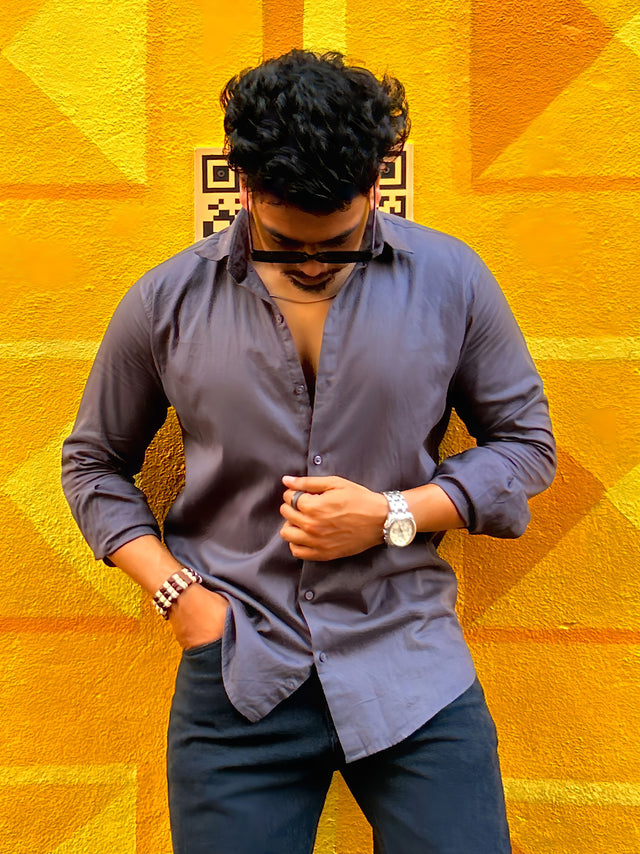 a man standing in front of a yellow wall
