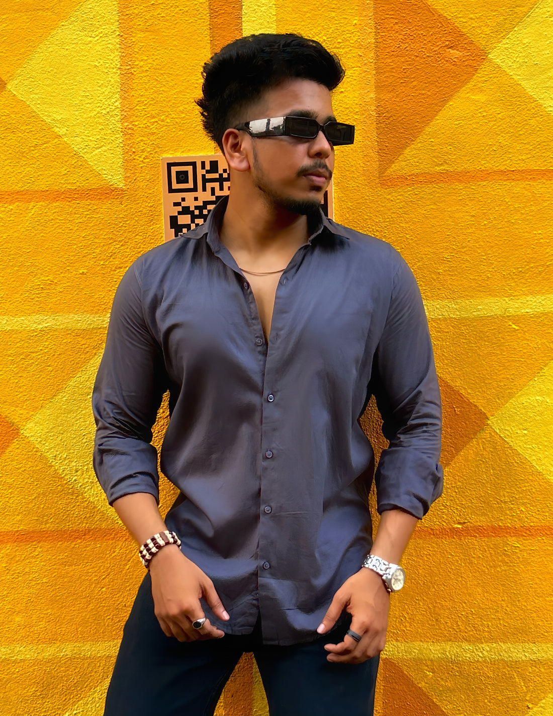 a man standing in front of a yellow wall