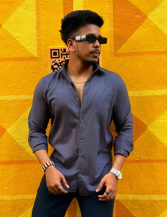 a man standing in front of a yellow wall