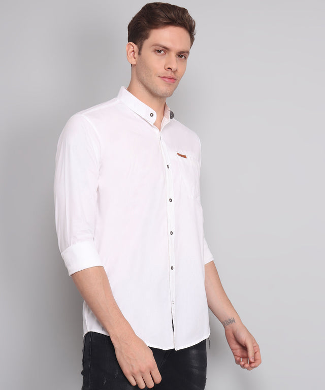 
a man wearing a white shirt and black pants
