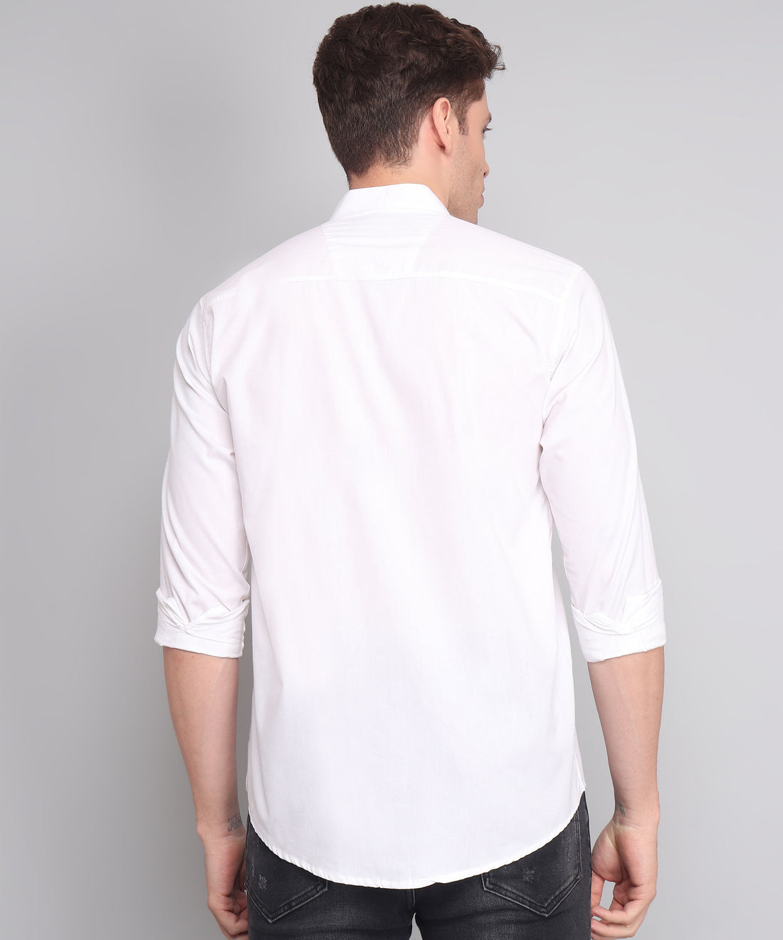 
a man wearing a white shirt and black jeans
