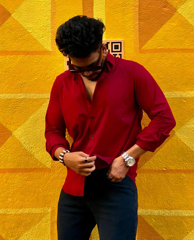 a man standing in front of a yellow wall