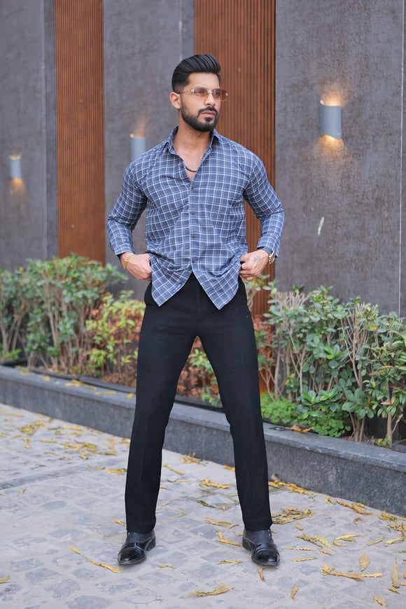 a man standing on a sidewalk with his hands on his hips