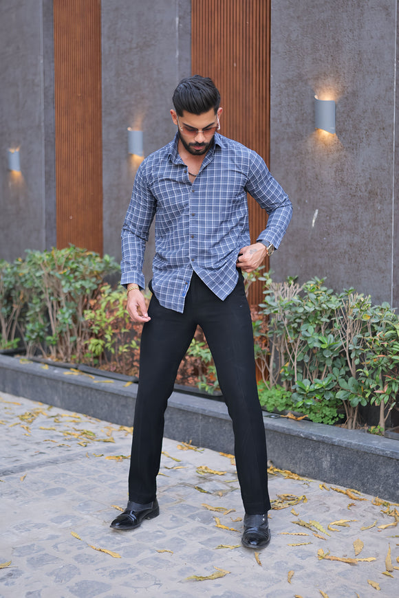 a man standing on a sidewalk with his hands on his hips