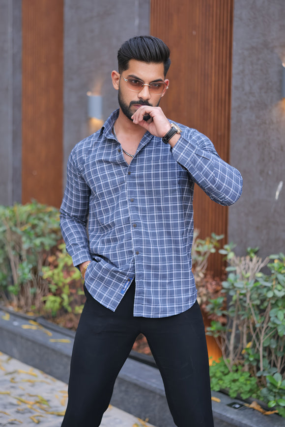 a man in a blue shirt and black pants