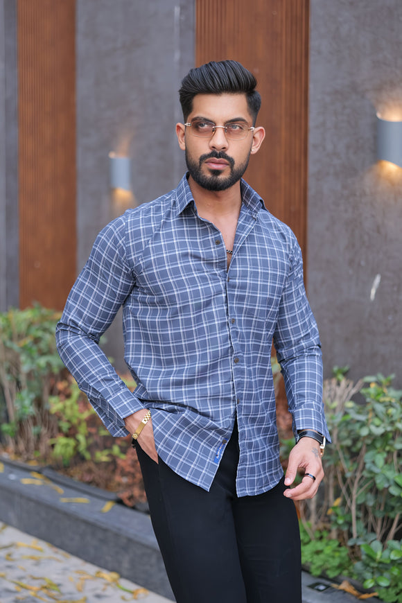 a man in a blue shirt and black pants