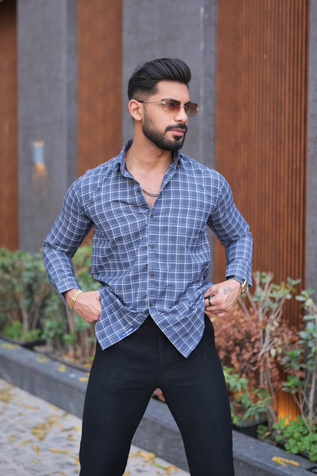 a man in a blue shirt and black pants