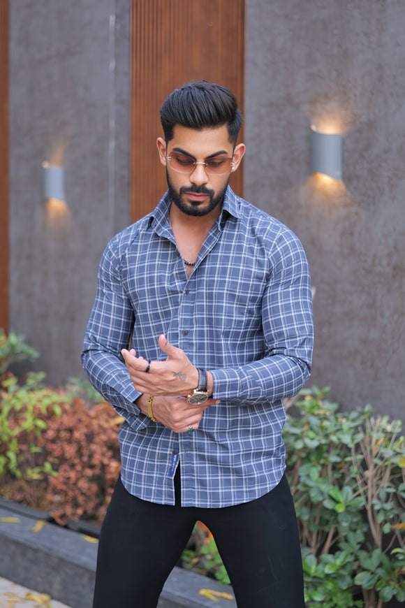 a man in a blue shirt and black pants