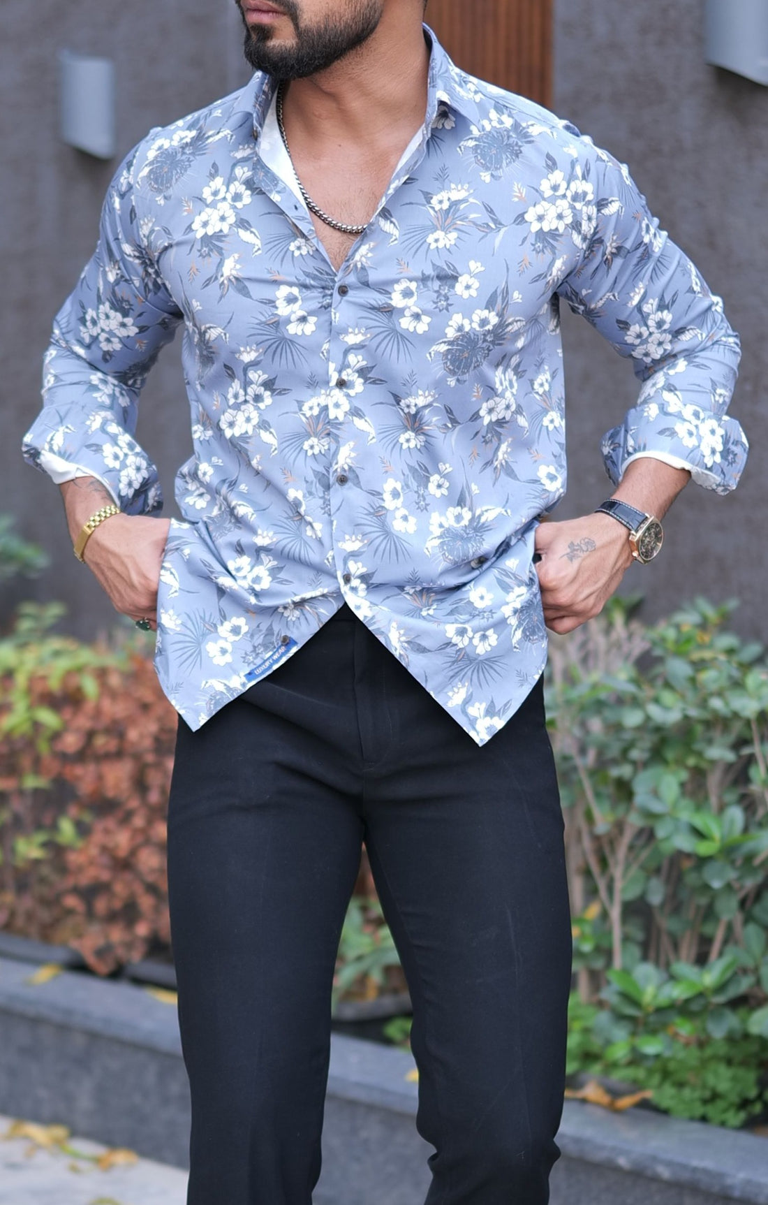 a man wearing a blue shirt and black pants