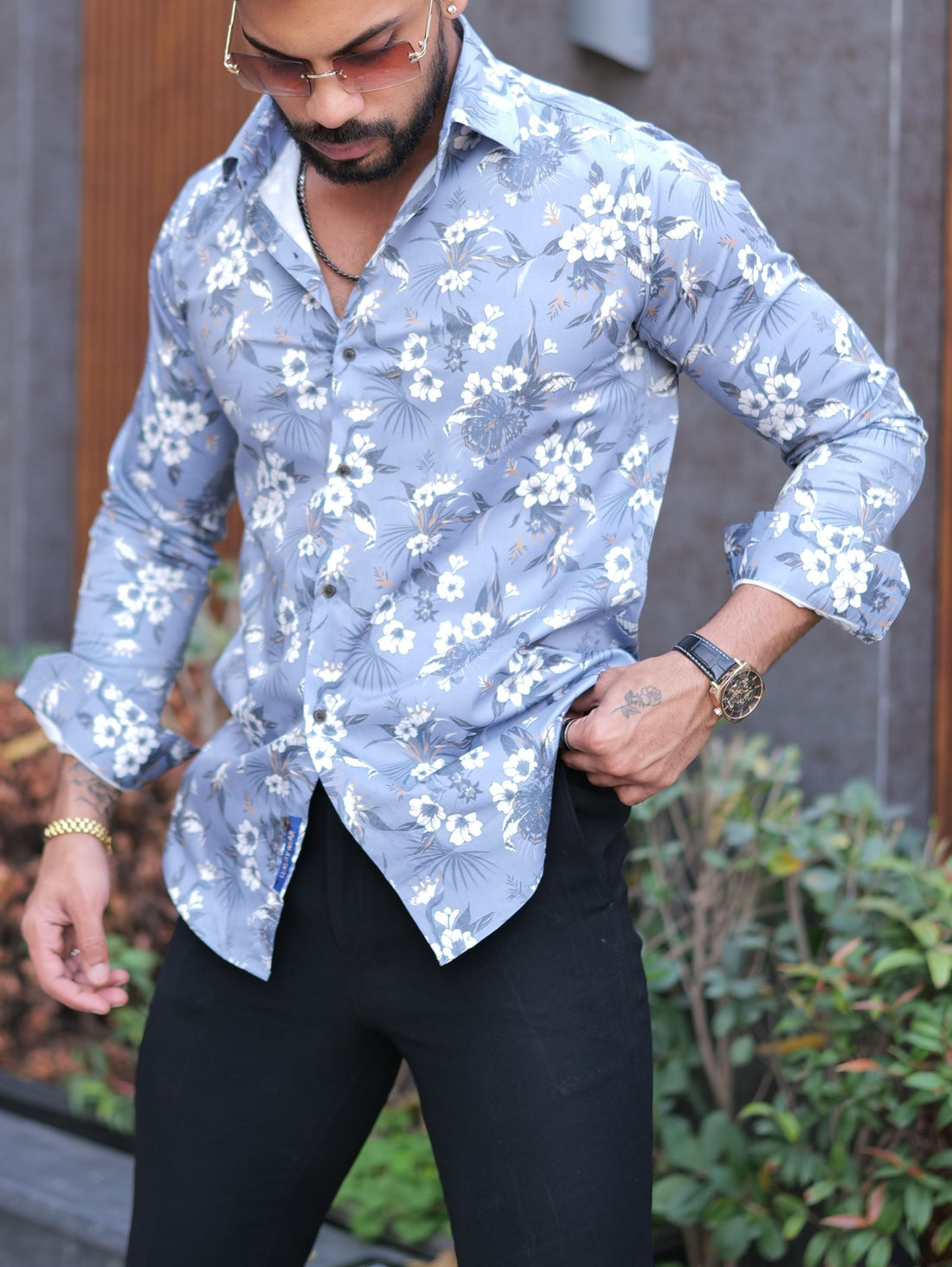 a man wearing a blue shirt and black pants