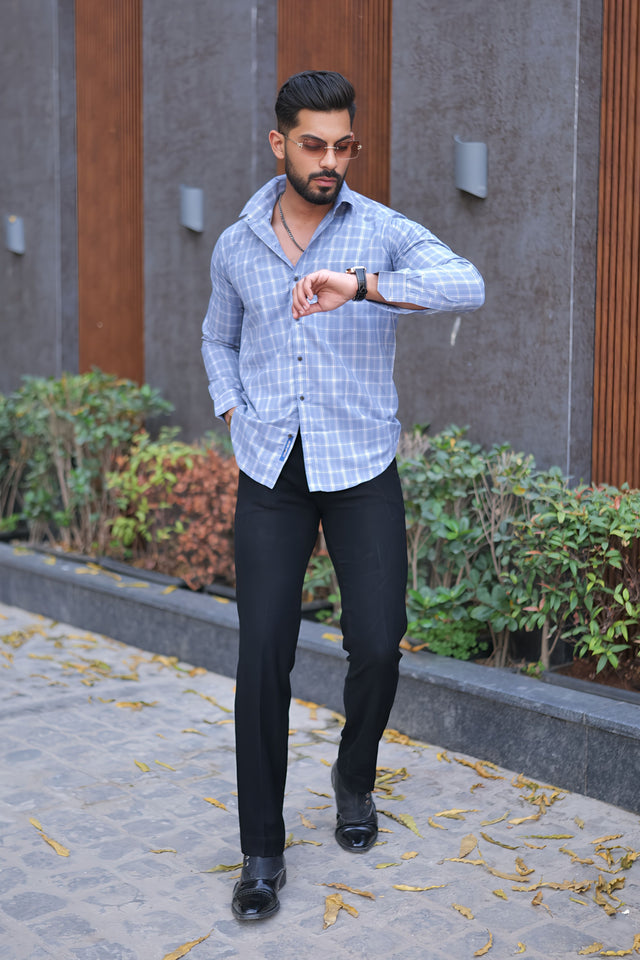 a man in a blue shirt and black pants