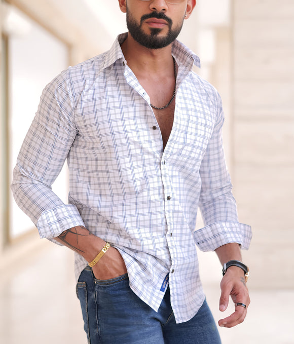 a man with a beard wearing a shirt and jeans