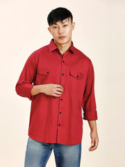 a man in a red shirt is posing for a picture