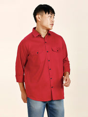 a man in a red shirt is standing