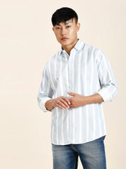 a man in a striped shirt poses for a picture