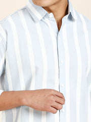 a man wearing a blue and white striped shirt