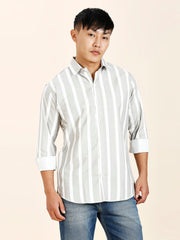 a man in a striped shirt poses for a picture