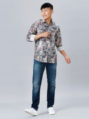 a man in a shirt and jeans poses for a picture