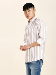 a man in a striped shirt poses for a picture