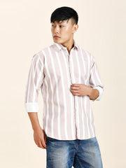 a man in a striped shirt poses for a picture