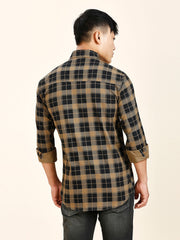 a man in a brown and black checkered shirt